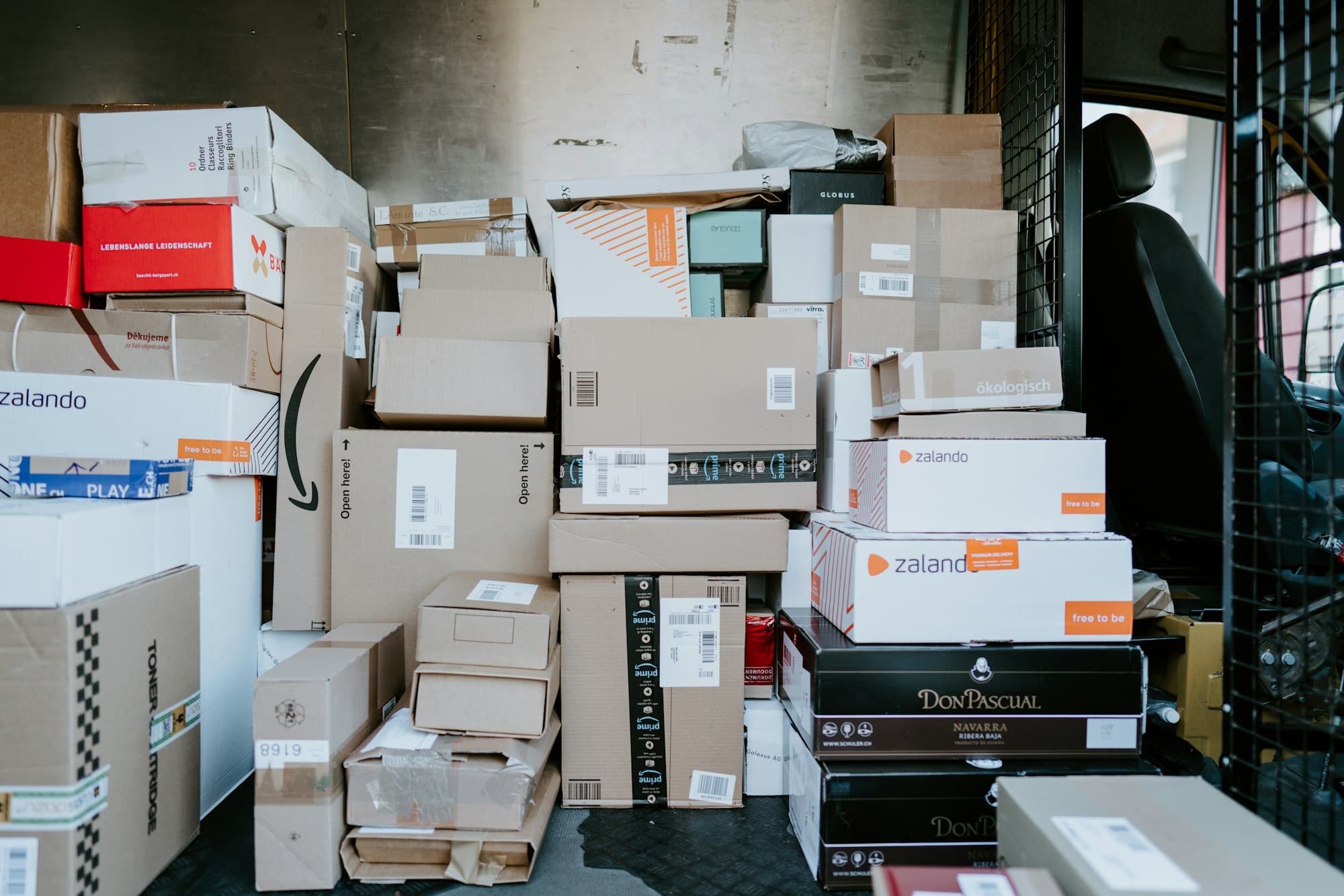 Parcels stacked in the back of a delivery van
