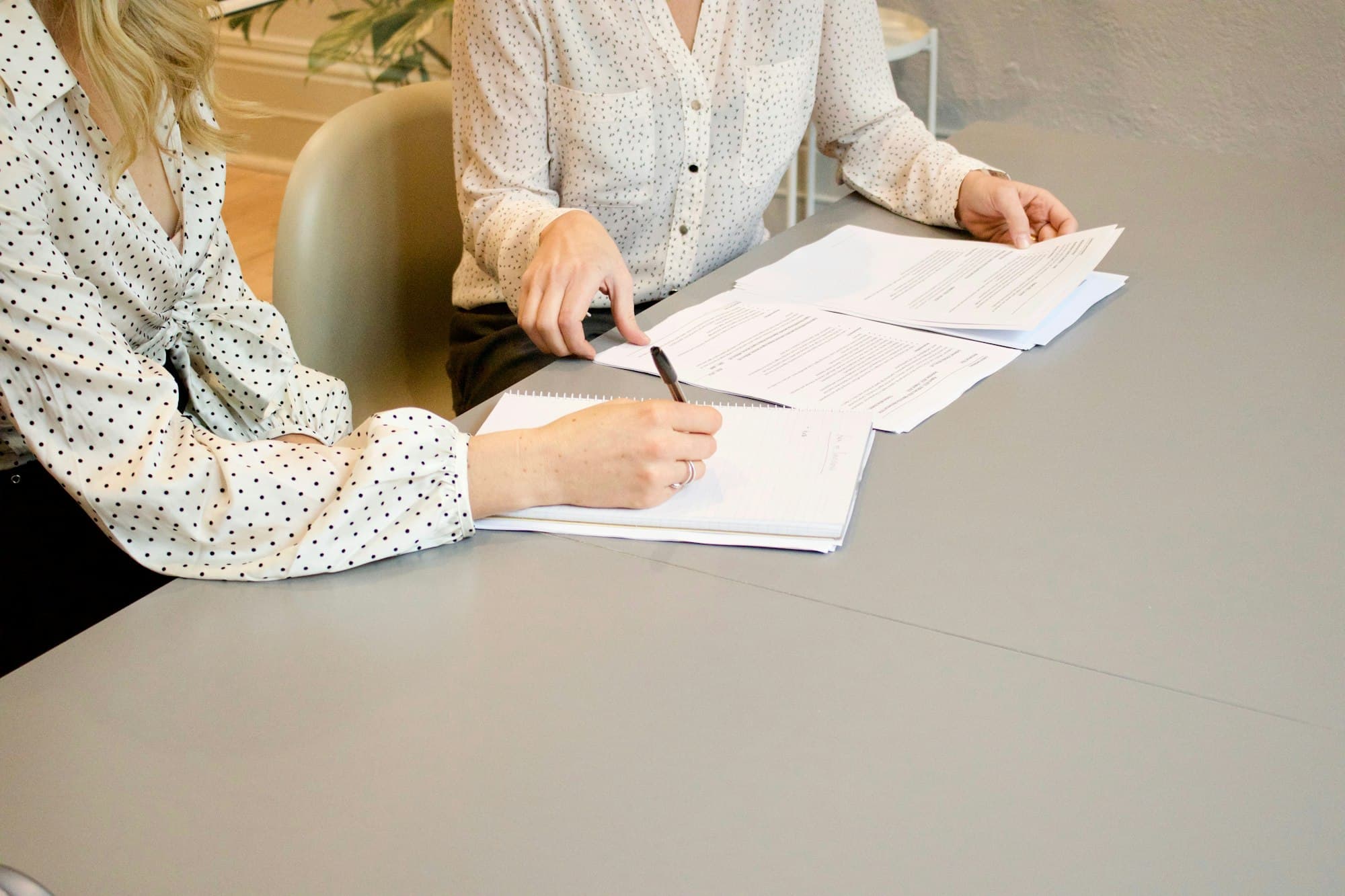 Documents being reviewed and signed at a desk