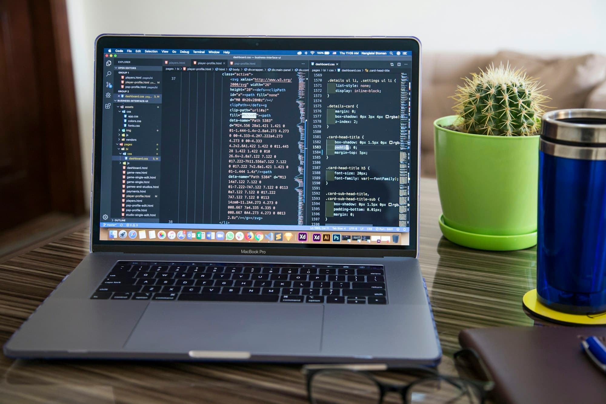 Laptop showing code on a developer's desk