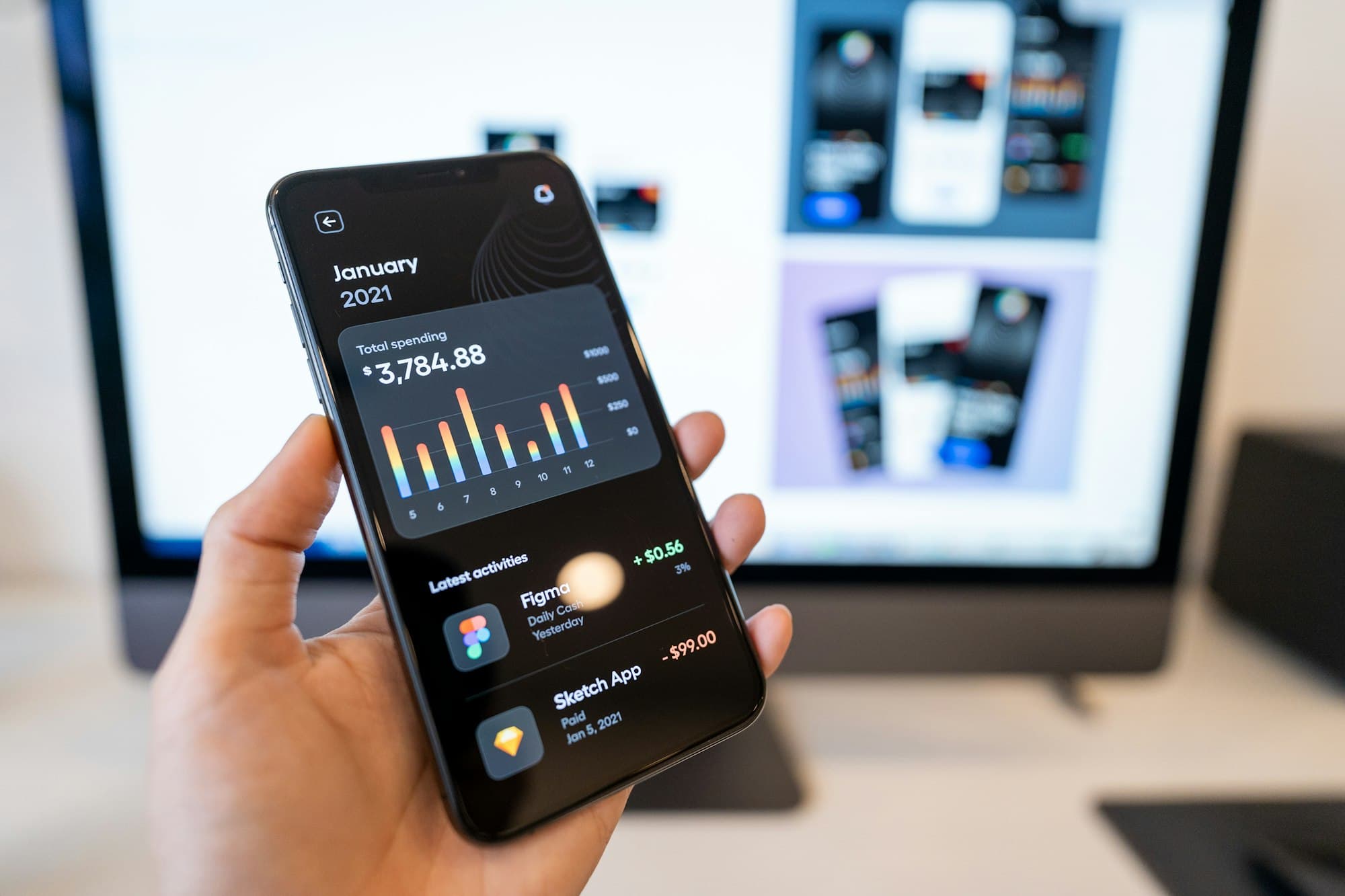 Hand holding a phone showing a data-rich app