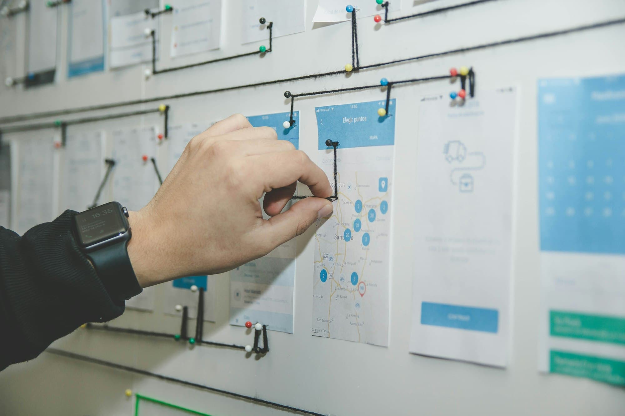Wireframes and notes pinned to a planning wall